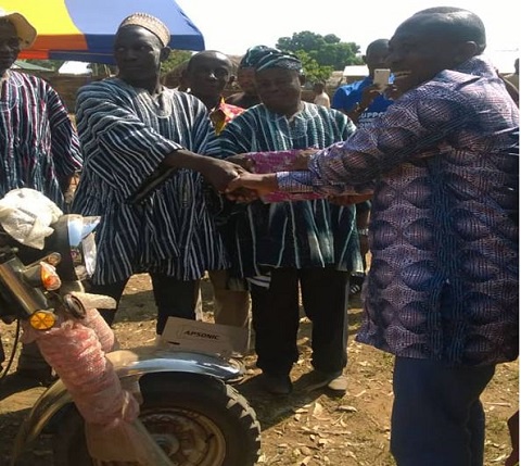 The MCE, Michael Sarkodie (R) handing over the tricycle to Thomas Mankire (L)