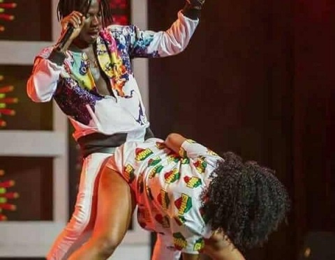 Stonebwoy on stage with a dancer
