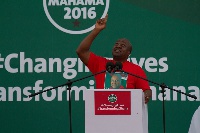 Former president John Mahama on a podium during a campaign tour