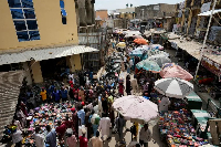 People shop at a market in Kano, Nigeria