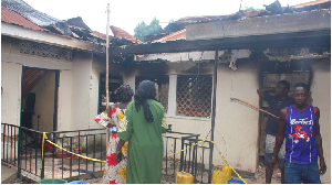 Residents inspect the damage of the fire that claimed six lives at Namulanda B Zone, Kajjansi Town