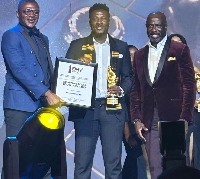 Asamoah Gyan receiving his award from Marcel Desailly