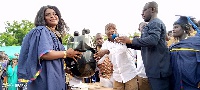 Mr Kwasi Bonzoh presenting a hairdryer to one of the graduates