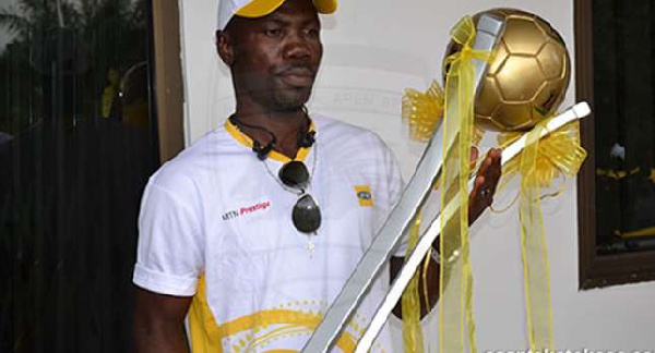 FA Cup ambassador, Joseph Hendricks, holding the trophy when trophy landed in Kumasi