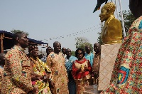 Vice President Amissah-Arthur being supported by other dignitaries to unveil the bust