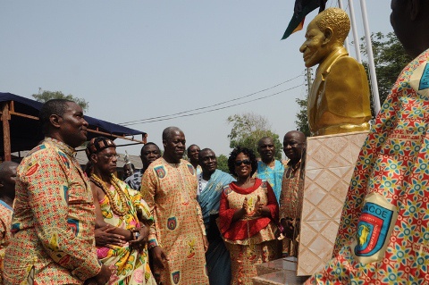 Vice President Amissah-Arthur being supported by other dignitaries to unveil the bust