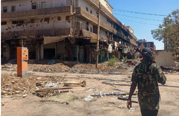 A fighter loyal to the Sudanese army patrols a market in Khartoum on March 24, 2025