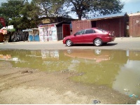 Waste water from the system seeps through the streets of Tema