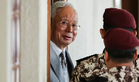 Malaysia's former Prime Minister Najib Razak is escorted by prison guards
