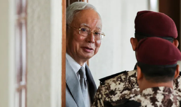Malaysia's former Prime Minister Najib Razak is escorted by prison guards