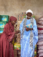 Dorcas Affo-Toffey shaking hands with the Jomoro Municipal Chief Iman