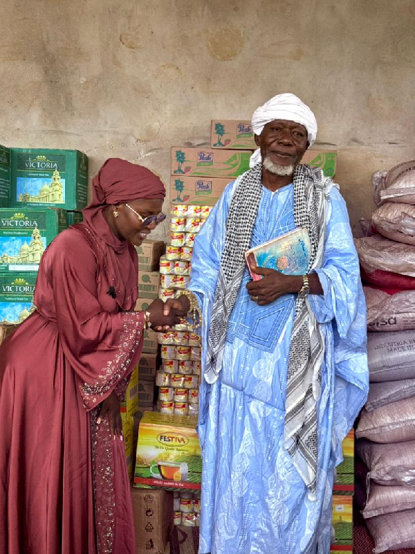 Dorcas Affo-Toffey shaking hands with the Jomoro Municipal Chief Iman