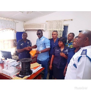 Nana Ofori Atta presenting the security items to the Kwabenya Police station