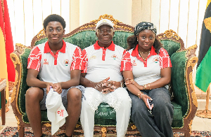 The Asantehene Otumfuo Osei Tutu II (M) and his children seated with him