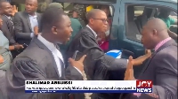 Francis-Xavier Sosu engaging in a scuffle with an immigration officer after client's re-arrest