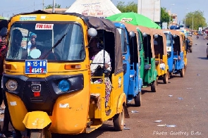 Tricycle riders in queue