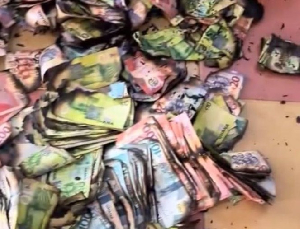 A photo of burnt cedi notes