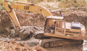 File photo of some miners mining with an excavator