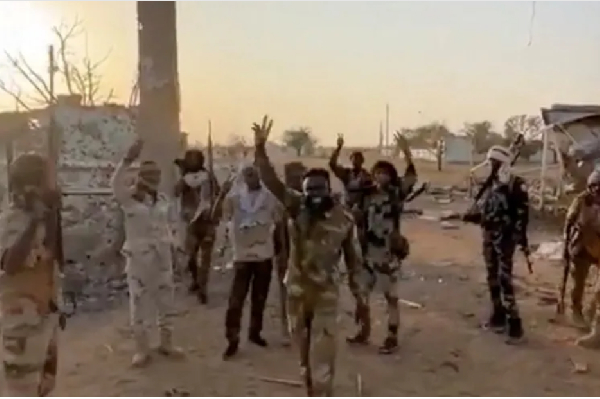 Members of the paramilitary RSF stand in front of the main gate of the 22nd SAF Infantry Division