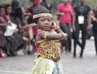 A child displaying her Adowa dance skills at the funeral grounds