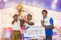 Proud students of Dayspring Montessori International lift their trophy