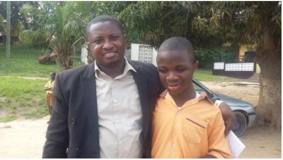 Raymond Ablorh with a student of one of the Schools for the Blind.