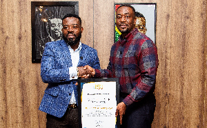 Richard Nii Armah Quaye with GhanaWeb's CEO, David Antwi, during the award presentation