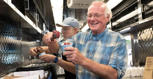 Ben Cohen and Jerry Greenfield (behind) handing out free ice cream to encourage people to vote