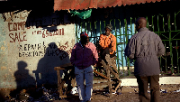 Gambians sit in the sun in Serrekunda, Gambia