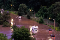 Cars sit stranded on the flooded Don Valley Parkway during a storm in Toronto