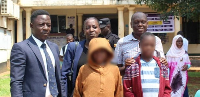 Mr Yekosi Musujja (left) poses with the survivors and their relatives at Jinja High Court