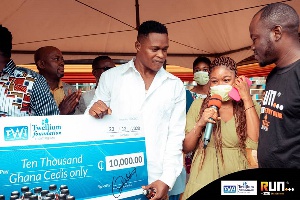 Sammy Adjei holding a dummy cheque