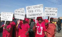 Residents clad in red hit the streets to register their opposition to crude oil exploration