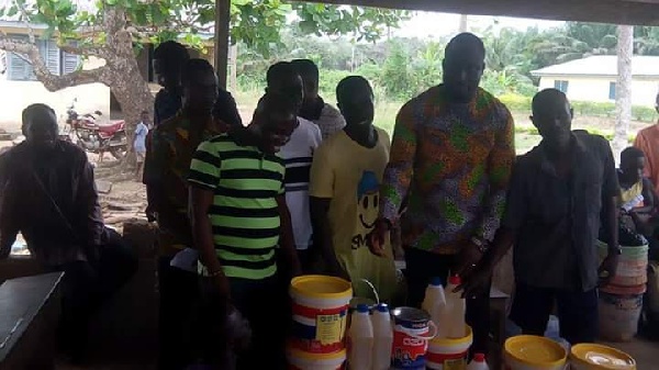 MCE for Nzema East, Frank Okpenyen handing over the items to the staff of the school