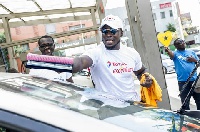 Stephen Appiah cleaning the windscreen of our customer vehicle