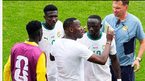 Thiaw (C) gives instructions to his players during a water break in the World Cup Group match Thiaw (C) gives instructions to his players during a water break in the World Cup Group match