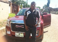 Kwabena Amissah standing by his new car