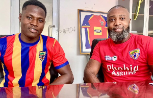 Abdul Aziz and a representative from Hearts of Oak