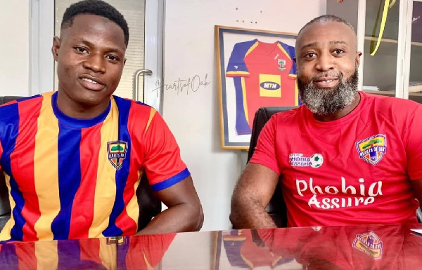 Abdul Aziz and a representative from Hearts of Oak