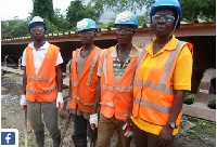 Woman miner with male colleagues.