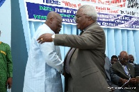 Rt. Rev. Emmanuel Marty (right) offers Nana Addo a firm handshake