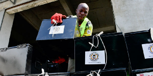 A worker arranges boxes containing electoral materials before their distribution