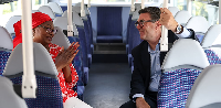 Britain's Prime Minister Andy Burnham speaks with Bemi Orojuogun during a bus ride in Bath