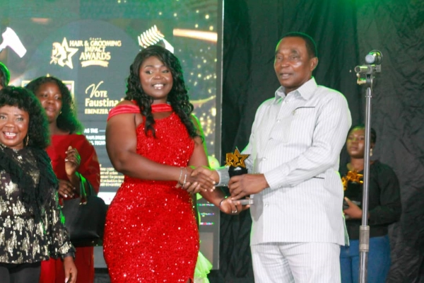 Rebecca Benle is seen receiving an award as the best Hair Plaiter of the year