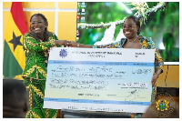Nana Oye Bampoe Addo presenting the cheque to Obuobia Darko-Opoku