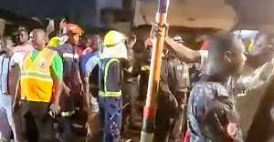 A crowd gathered at the site of the collapsed building