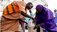 Yaanama Abba, a 45-year-old mother of six children, receives pinto beans distributed by WFP