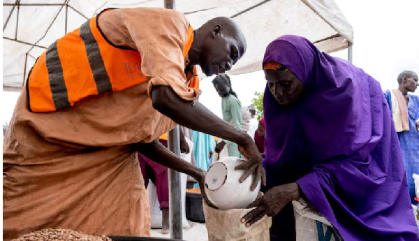 Yaanama Abba, a 45-year-old mother of six children, receives pinto beans distributed by WFP