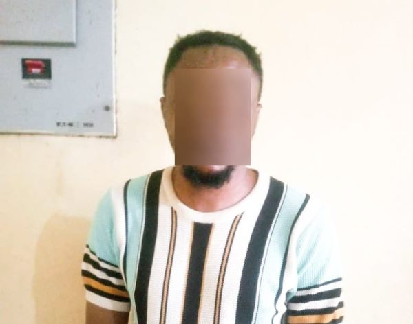 The suspect Bright Aweh with his face covered