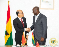 Dr Cassiel Ato Forson (R) pictured with Ambassador Tong Defa